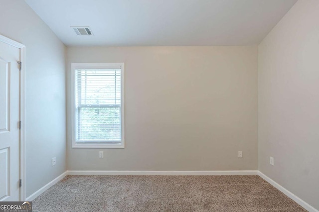 empty room with carpet floors and baseboards