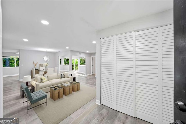 living area featuring baseboards, recessed lighting, and wood finished floors