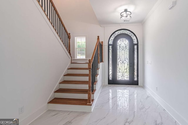 140 Maranatha Trl, Lawrenceville, GA 30045 - entrance foyer with marble finish floors, baseboards, stairs, and ornamental molding