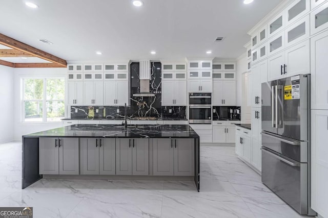 140 Maranatha Trl, Lawrenceville, GA 30045 - kitchen with stainless steel appliances, recessed lighting, light marble finish flooring, tasteful backsplash, and wall chimney range hood