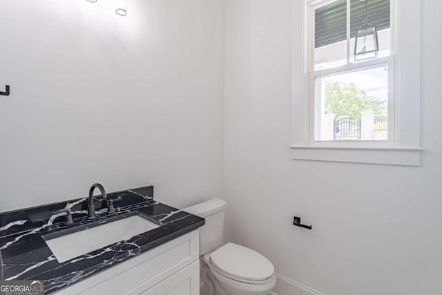 140 Maranatha Trl, Lawrenceville, GA 30045 - half bathroom featuring toilet, vanity, and baseboards