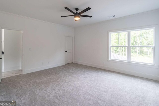 140 Maranatha Trl, Lawrenceville, GA 30045 - empty room featuring carpet floors, crown molding, a ceiling fan, and baseboards
