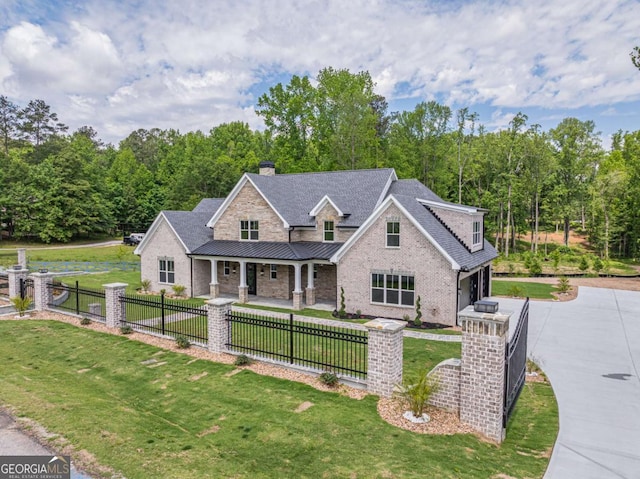 140 Maranatha Trl, Lawrenceville, GA 30045 - view of front of house featuring a porch, driveway, an attached garage, a standing seam roof, and a chimney