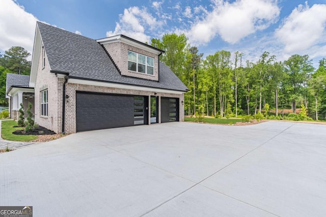 140 Maranatha Trl, Lawrenceville, GA 30045 - view of home's exterior featuring driveway, brick siding, and roof with shingles