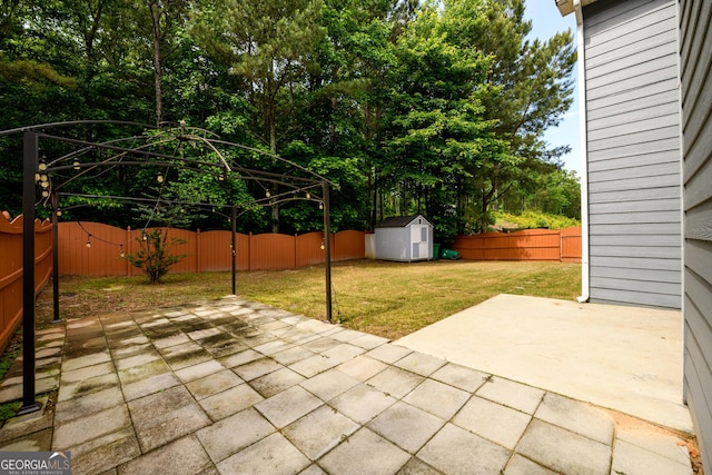 view of patio / terrace featuring a storage unit, an outdoor structure, and a gate