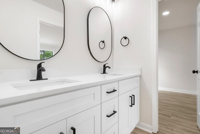 683 Highland Ct, Marietta, GA 30068 - bathroom featuring double vanity, wood finished floors, and baseboards