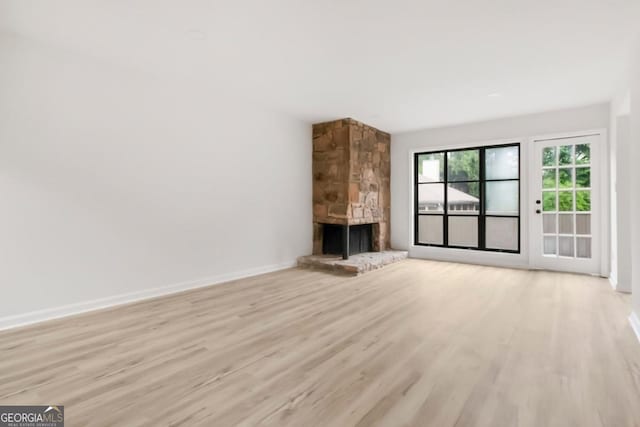 683 Highland Ct, Marietta, GA 30068 - unfurnished living room with light wood finished floors, a fireplace, and baseboards