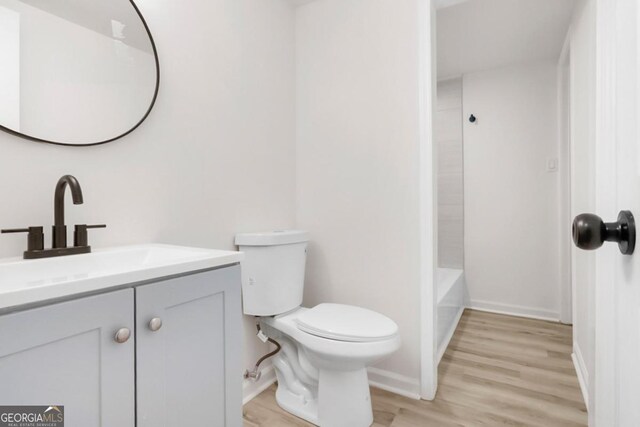 683 Highland Ct, Marietta, GA 30068 - full bathroom with toilet, wood finished floors, vanity, and baseboards