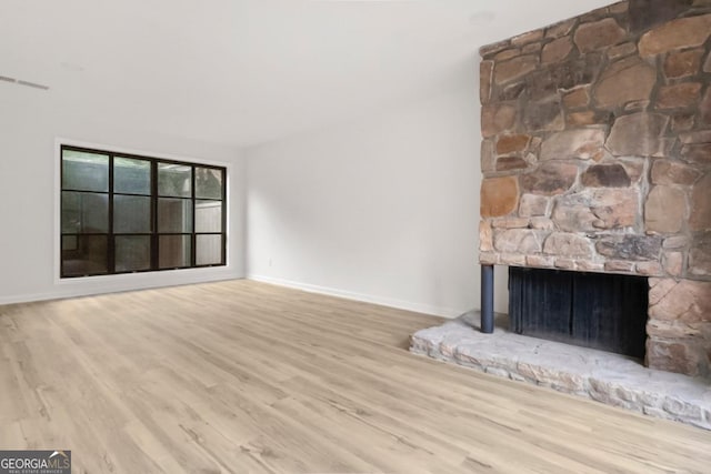 683 Highland Ct, Marietta, GA 30068 - unfurnished living room with a stone fireplace, wood finished floors, and baseboards