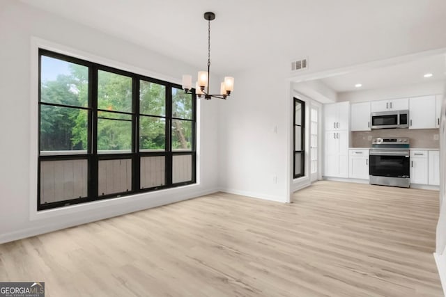683 Highland Ct, Marietta, GA 30068 - unfurnished living room with light wood-type flooring, a chandelier, baseboards, and recessed lighting