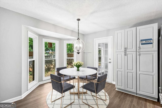 191 Nectar Pl, Dallas, GA 30132 - dining area featuring a chandelier, dark wood-type flooring, a textured ceiling, and baseboards