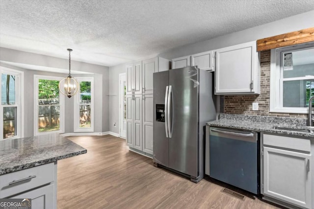 191 Nectar Pl, Dallas, GA 30132 - kitchen featuring dishwasher, stainless steel refrigerator with ice dispenser, a sink, a textured ceiling, and light wood-type flooring