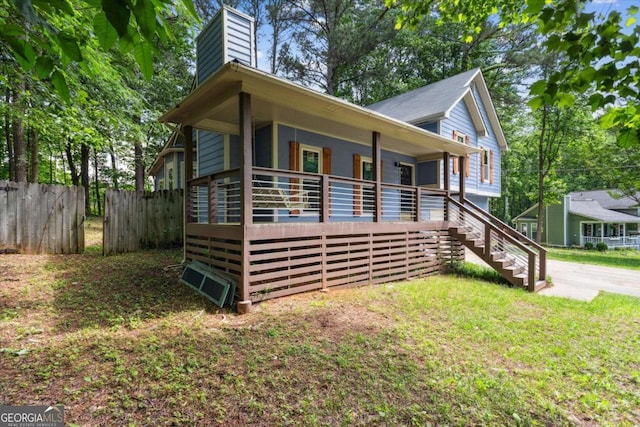 191 Nectar Pl, Dallas, GA 30132 - view of side of home with a chimney, a porch, fence, and stairs