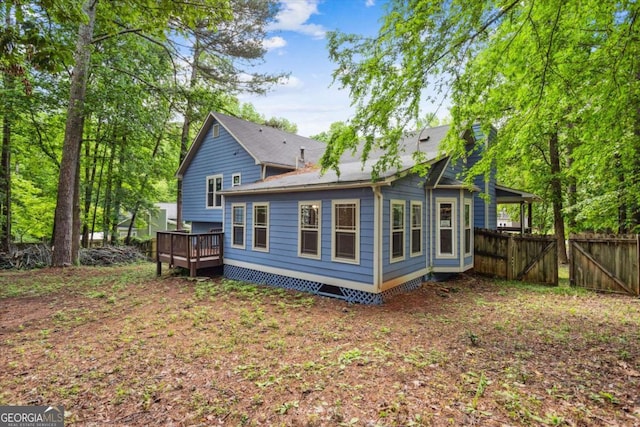 191 Nectar Pl, Dallas, GA 30132 - back of house featuring fence, a wooden deck, a chimney, and a gate