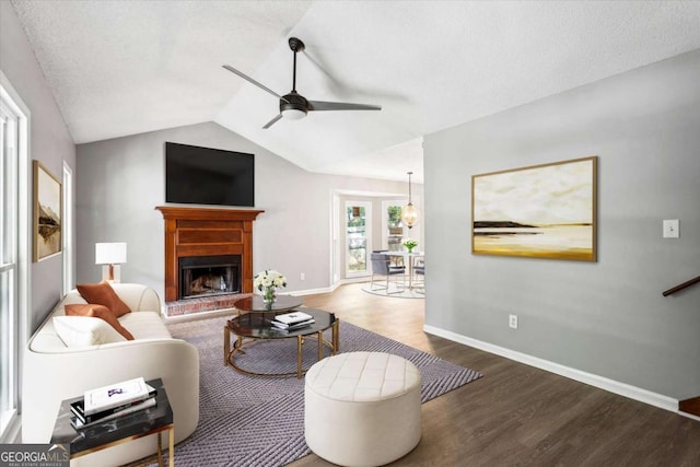 191 Nectar Pl, Dallas, GA 30132 - living area featuring wood finished floors, ceiling fan, a fireplace with raised hearth, baseboards, and lofted ceiling