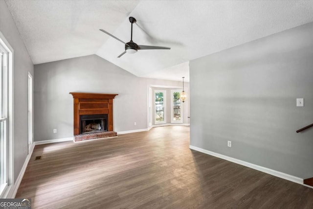 191 Nectar Pl, Dallas, GA 30132 - unfurnished living room with ceiling fan, wood finished floors, a fireplace with raised hearth, vaulted ceiling, and baseboards