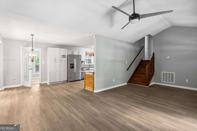 191 Nectar Pl, Dallas, GA 30132 - unfurnished living room with a chandelier, a ceiling fan, wood finished floors, plenty of natural light, and lofted ceiling