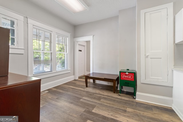 foyer entrance with wood finished floors and baseboards