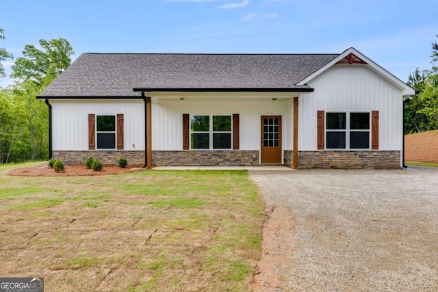 0 Grogan Rd, Buchanan, GA 30113 - modern farmhouse style home featuring stone siding, roof with shingles, and a front lawn