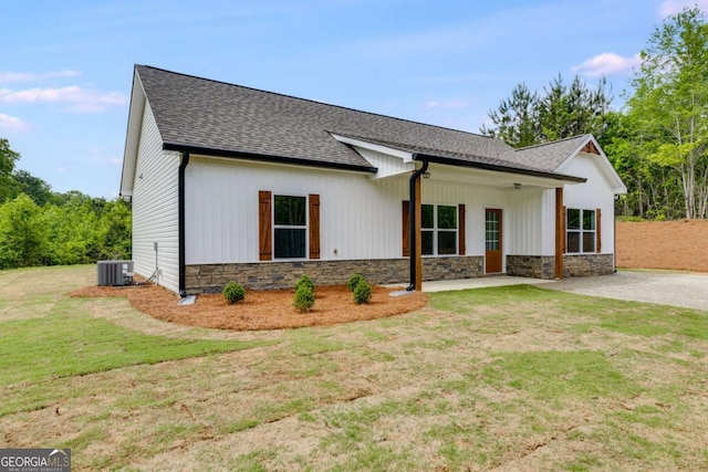 0 Grogan Rd, Buchanan, GA 30113 - modern farmhouse style home with stone siding, central air condition unit, a shingled roof, a front lawn, and a patio area