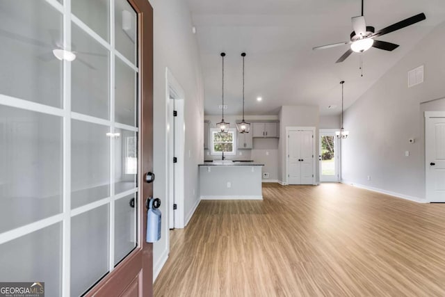 0 Grogan Rd, Buchanan, GA 30113 - unfurnished living room featuring ceiling fan, light wood-type flooring, baseboards, a chandelier, and high vaulted ceiling