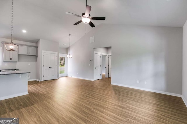 0 Grogan Rd, Buchanan, GA 30113 - unfurnished living room featuring a ceiling fan, baseboards, a chandelier, light wood finished floors, and high vaulted ceiling