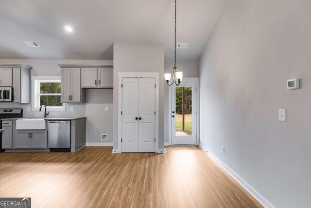 0 Grogan Rd, Buchanan, GA 30113 - kitchen featuring stainless steel appliances, gray cabinetry, light wood-style flooring, and baseboards