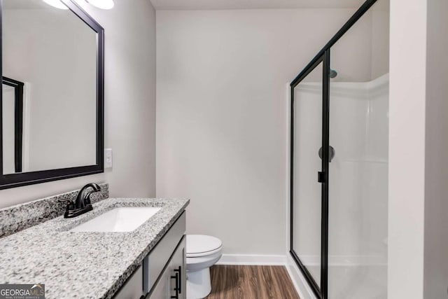 0 Grogan Rd, Buchanan, GA 30113 - bathroom featuring a stall shower, wood finished floors, vanity, toilet, and baseboards