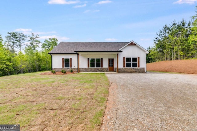 0 Grogan Rd, Buchanan, GA 30113 - modern inspired farmhouse featuring a front yard, stone siding, a shingled roof, and driveway