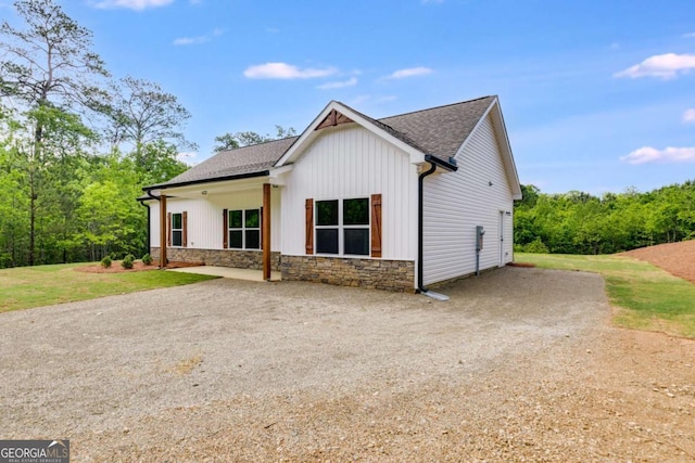 0 Grogan Rd, Buchanan, GA 30113 - modern farmhouse with stone siding, a shingled roof, and a front yard