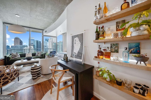 860 Peachtree St NE Unit 1513, Atlanta, GA 30308 - living room with wood finished floors, a bar, and a view of skyline