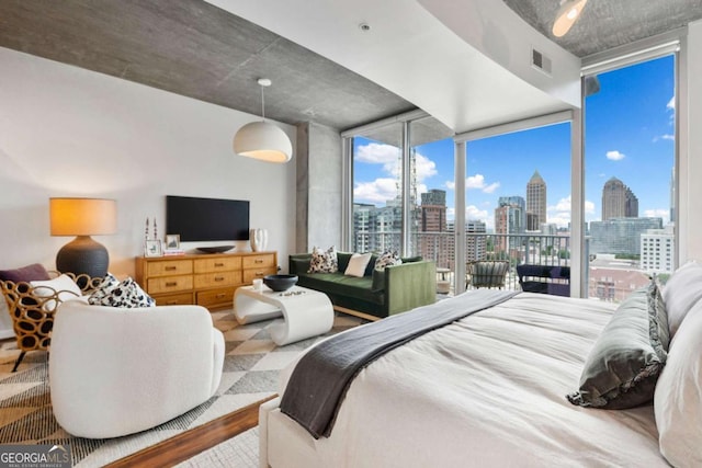 860 Peachtree St NE Unit 1513, Atlanta, GA 30308 - bedroom featuring floor to ceiling windows and wood finished floors