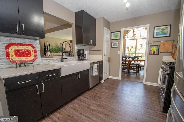 11 Line Creek Cir, Sharpsburg, GA 30277 - kitchen with stainless steel appliances, dark wood-style floors, dark cabinetry, a sink, and light countertops