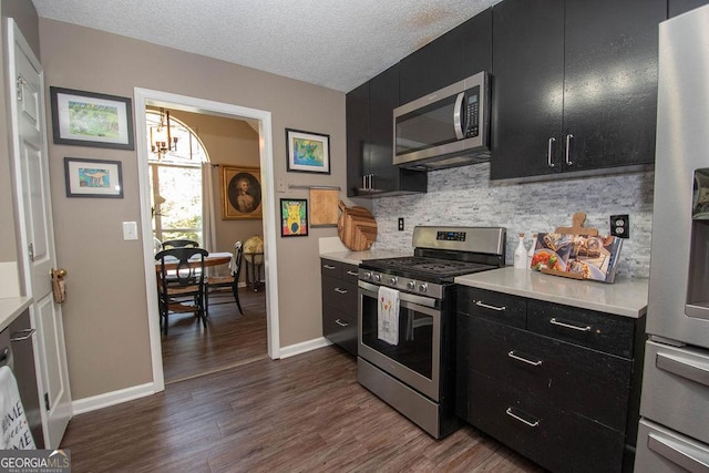 11 Line Creek Cir, Sharpsburg, GA 30277 - kitchen with stainless steel appliances, dark cabinets, light countertops, dark wood-type flooring, and a textured ceiling