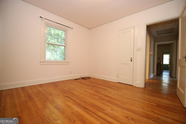 empty room with light wood-type flooring and baseboards