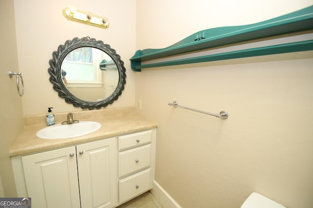half bath featuring vanity, tile patterned floors, and toilet