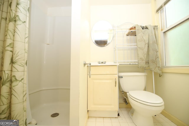 bathroom featuring a shower with shower curtain, tile patterned flooring, toilet, baseboards, and vanity