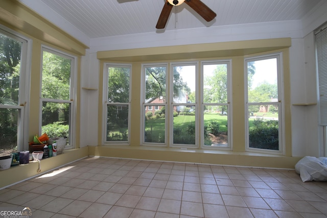 unfurnished sunroom with tile patterned floors and crown molding