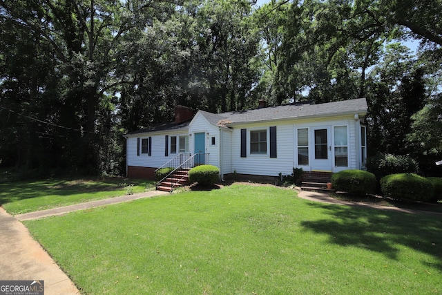 view of front of home featuring a front lawn and a chimney