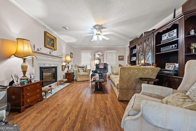 2810 Jodeco Ter, Jonesboro, GA 30236 - living area with ceiling fan, wood finished floors, crown molding, a textured ceiling, and a fireplace