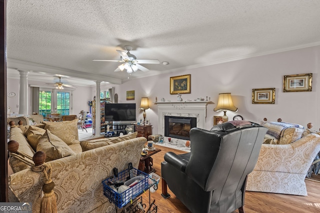 2810 Jodeco Ter, Jonesboro, GA 30236 - living area with decorative columns, a ceiling fan, ornamental molding, wood finished floors, and a premium fireplace
