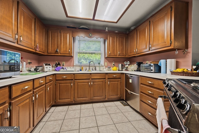 2810 Jodeco Ter, Jonesboro, GA 30236 - kitchen with a sink, stainless steel appliances, light countertops, brown cabinets, and light tile patterned floors