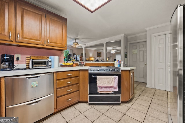 2810 Jodeco Ter, Jonesboro, GA 30236 - kitchen with gas stove, a peninsula, a ceiling fan, refrigerator, and brown cabinetry