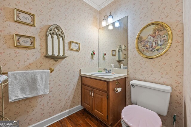 2810 Jodeco Ter, Jonesboro, GA 30236 - half bathroom with wood finished floors, ornamental molding, toilet, and vanity