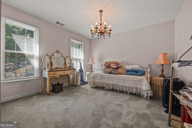 2810 Jodeco Ter, Jonesboro, GA 30236 - carpeted bedroom featuring multiple windows, a chandelier, a textured ceiling, and baseboards