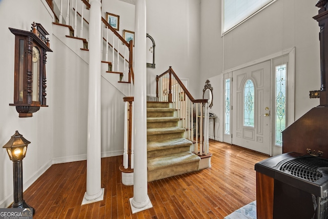 2810 Jodeco Ter, Jonesboro, GA 30236 - entrance foyer with wood-type flooring, a towering ceiling, stairs, and baseboards