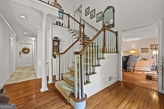 2810 Jodeco Ter, Jonesboro, GA 30236 - stairway with ornamental molding, hardwood / wood-style floors, baseboards, decorative columns, and recessed lighting