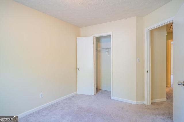 unfurnished bedroom featuring carpet flooring, a closet, and baseboards