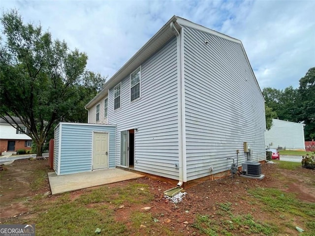 rear view of property featuring a patio area and central air condition unit
