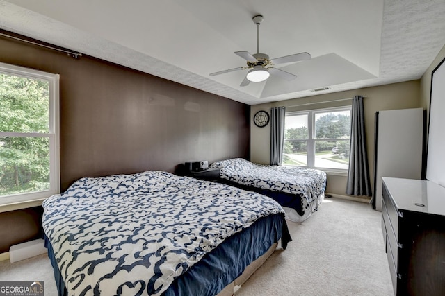 3668 Burel Mill Dr, Buford, GA 30519 - bedroom with light colored carpet, a tray ceiling, baseboards, and a ceiling fan